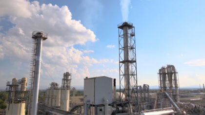 Industrial chimneys and installations in a chemical complex under blue sky