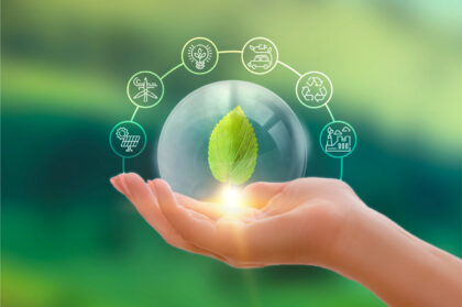 Hand with a leaf in a glass sphere symbolizing CO₂ reduction and sustainable energy