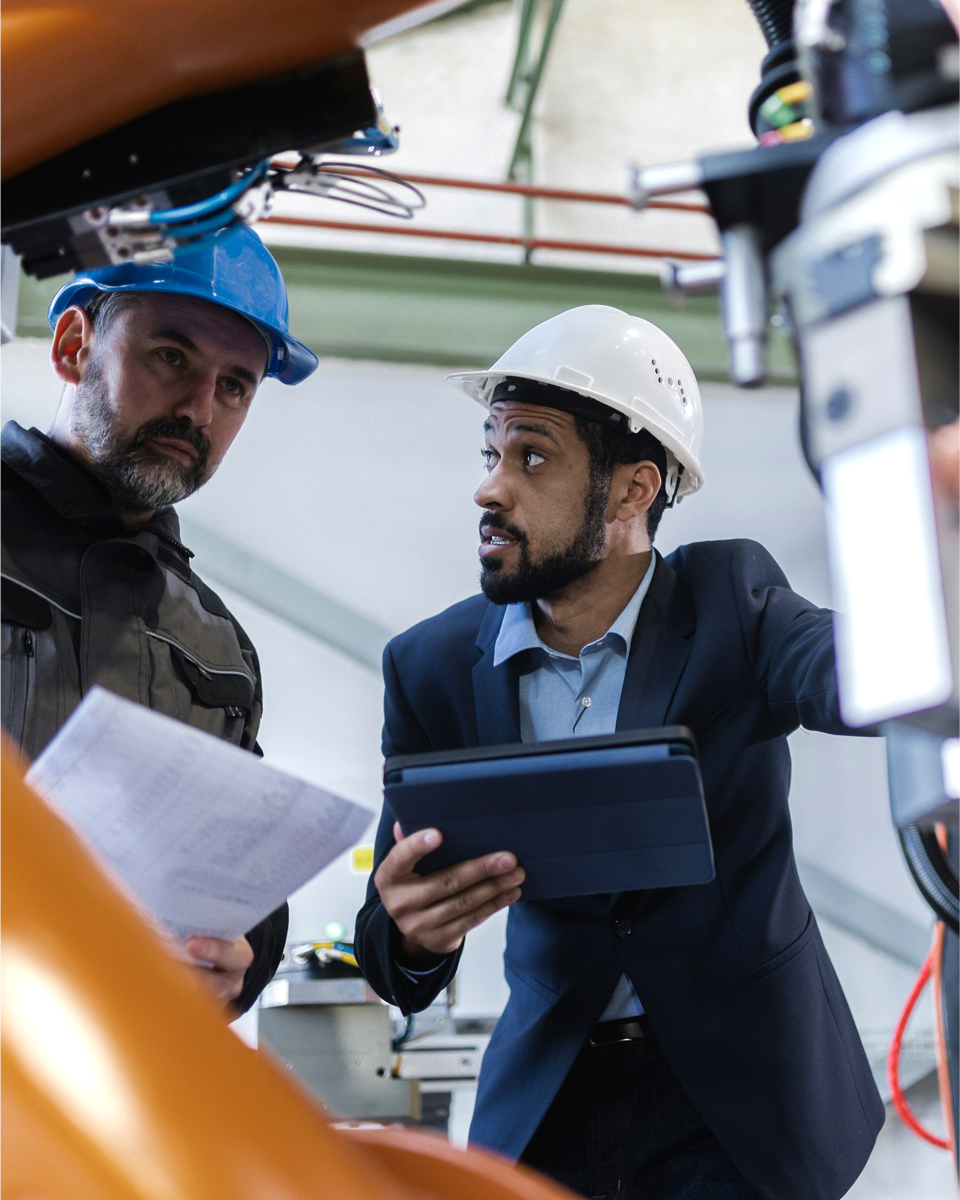 Two technicians discussing heat recovery options in an industrial environment