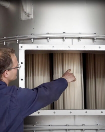 Technician pointing at bundles in Heat Matrix polymer air preheater