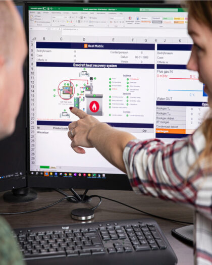 Two Heat Matrix employees analyzing a heat recovery system on a computer screen.